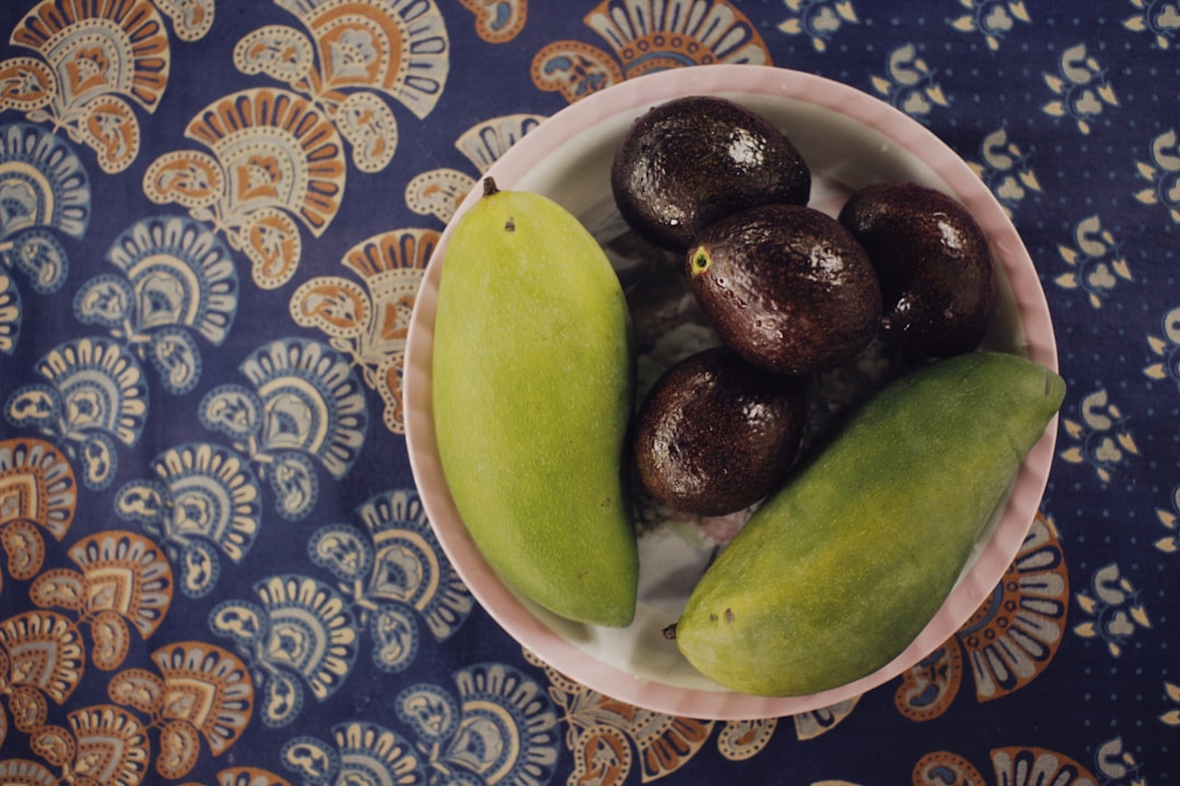 a bowl filled with fruit sitting on top of a table